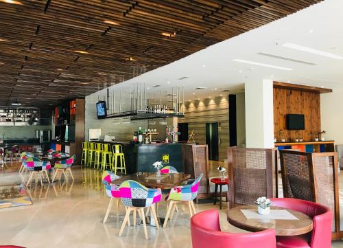 a restaurant with tables and chairs in a room at Golden Tulip City Centre Gurgaon in Gurgaon