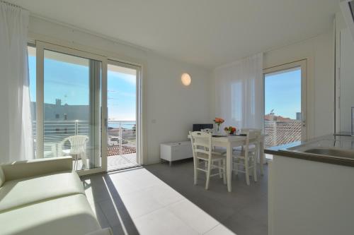 a kitchen and dining room with a view of the ocean at Residence Al Molo - Agenzia Cocal in Caorle