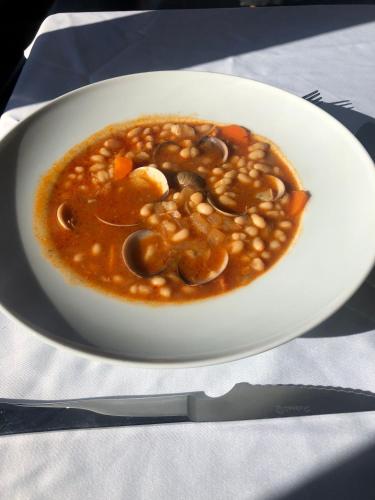 a bowl of soup on a plate on a table at Hotel Seva in Seva