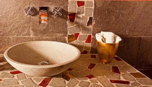 a bathroom with a toilet and a trash can at Cascina Canée in Angera