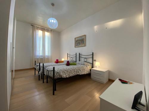 A bed or beds in a room at Ca' Santa Marta Apartment