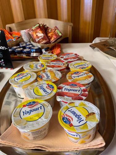 a tray of yogurt containers on a table at Hotel - Restaurant Eierhals am Ägerisee in Oberägeri