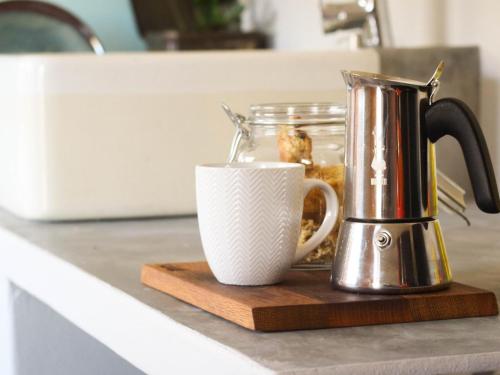 a coffee maker and a coffee cup on a counter at Starry Starry Night - Route 62 in Montagu