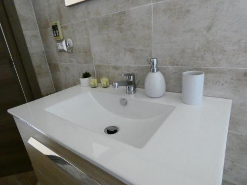 a bathroom with a white sink in a room at B&B MaDie in Castelsardo
