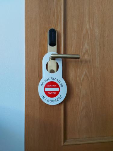 a door opener with a sign on it at Penzion Bird's Nest in Brno