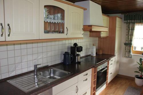 a kitchen with a sink and a counter top at Ferienwohnung Sattler in Neukirchen am Teisenberg