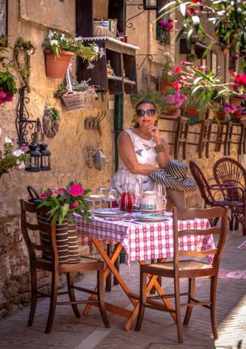 a woman sitting at a table with a table cloth at Casa Isabella B&B in Rocca San Giovanni