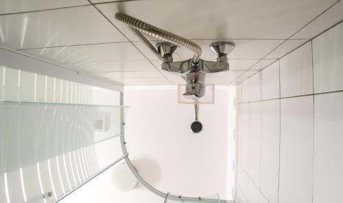 a shower head on a ceiling in a bathroom at La Moșie Bolovani in Bolovani