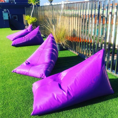 a group of purple pillows sitting on the grass at Embryo Hotel  in Pattaya Central