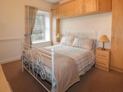 a bedroom with a bed and a window at Lavender Cottage in Belper