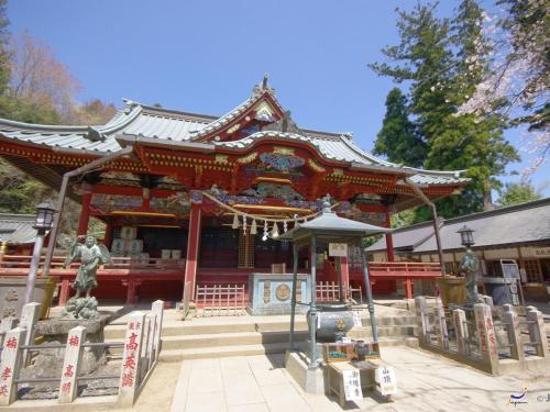 a chinese temple with a statue in front of it at Hotel Wing International Sagamihara in Sagamihara