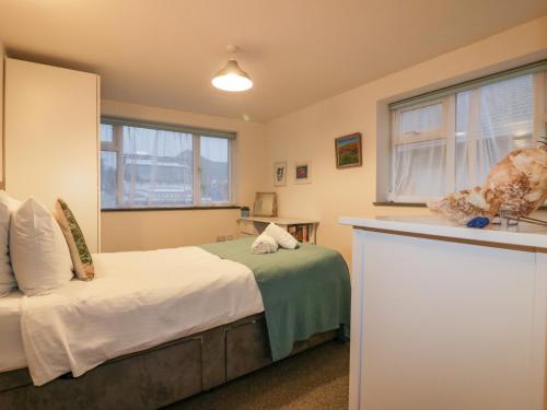 a bedroom with a bed and a window at Five Elements Barn in Truro