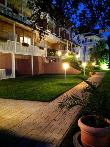 a courtyard of a building at night with a plant at Residenz am See in Sankt Kanzian