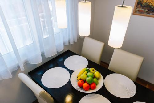 a table with a bowl of fruit on a plate at Irish House Međugorje in Međugorje