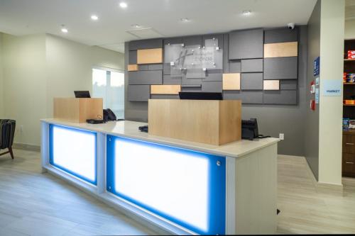 an office counter with boxes on top of it at Holiday Inn Express & Suites - Fort Myers Airport by IHG in Fort Myers