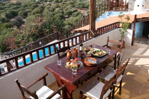 a table with food on top of a balcony at Elounda Traditional Homes of Crete in Elounda