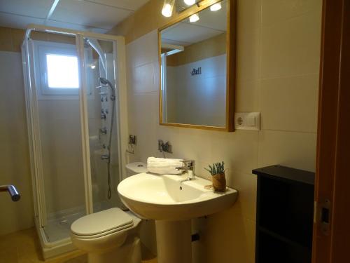 a bathroom with a sink and a toilet and a shower at Apartamentos Punta Cormorán in La Manga del Mar Menor
