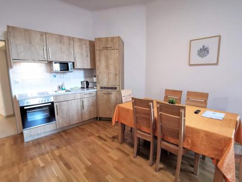 a kitchen with a table and chairs and a kitchen with a stove at Apartments Hellwagstraße in Vienna