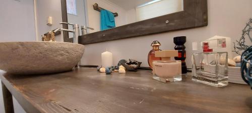 a counter with a sink and candles on it at Symi . VILLA CALME (Sur la Mer). in Symi