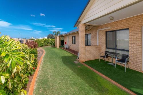 a yard with chairs and a house at Comfort Inn & Suites Karratha in Karratha