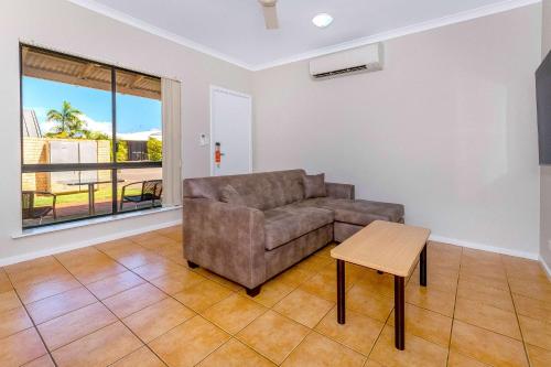 a living room with a couch and a table at Comfort Inn & Suites Karratha in Karratha