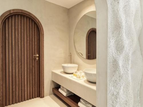 a bathroom with a sink and a mirror at Mykonos Earth Suites in Mýkonos City