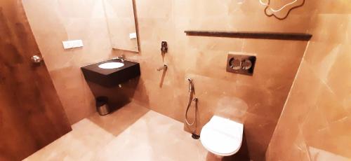 a bathroom with a toilet and a sink at Mayda Inn- A Boutique Hotel in New Delhi