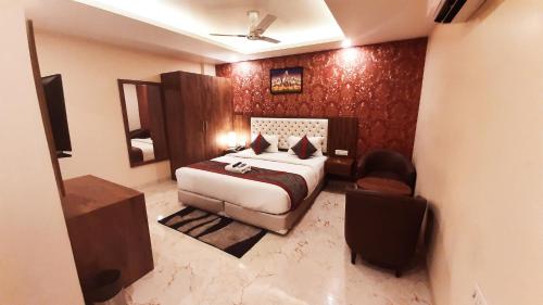 a hotel room with a bed and a chair at Mayda Inn- A Boutique Hotel in New Delhi
