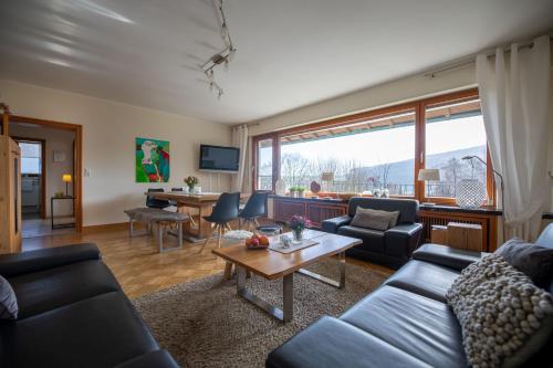 a living room with a couch and a table at Landhaus Mettenberg in Eslohe