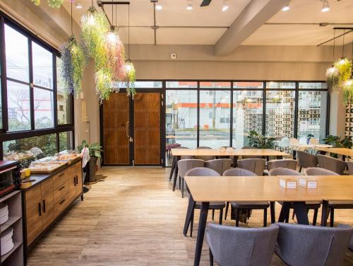 a restaurant with tables and chairs and windows at Taitung Sun forest in Taitung City