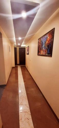 a hallway with a painting on the wall and a painting at Mayda Inn- A Boutique Hotel in New Delhi