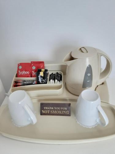 a tray with a tea pot and cups on it at The Cardoun in Blackpool