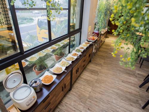 a buffet line with plates of food in a window at Taitung Sun forest in Taitung City