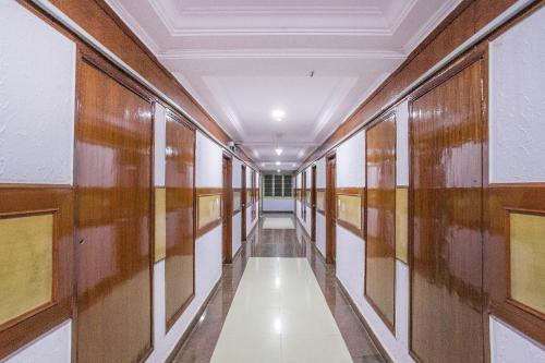 a corridor in a building with wooden walls and a ceiling at Hotel Chetan International in Bengaluru