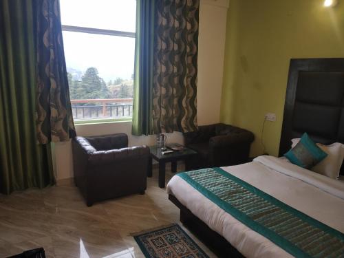 a hotel room with a bed and a window at ROYAL BREEZE HOTEL & RESTAURANT Received Most Rated Traveller Award Property For Year 2023-2024 !! in Mussoorie