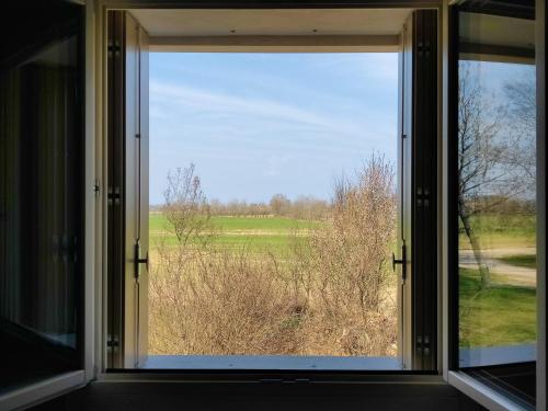 an open window with a view of a field at BERTESINA325 Superior Apartment in Vicenza