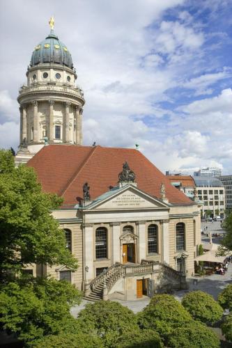 a building with a clock tower on top of it at Novotel Suites Berlin City Potsdamer Platz in Berlin