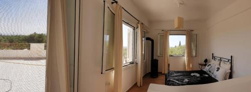 a room with a bed and a window in a room at Villa Stamatis in Áyioi Apóstoloi