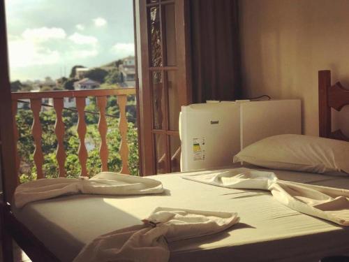 Ένα ή περισσότερα κρεβάτια σε δωμάτιο στο Pousada Gira-Sol