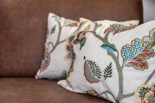 a pillow with a bird pattern on a couch at Der Bachwirt in Maria Alm am Steinernen Meer