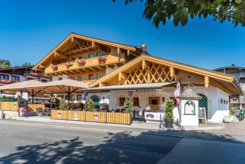 a building with a restaurant in front of it at Der Bachwirt in Maria Alm am Steinernen Meer