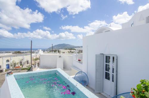 a villa with a swimming pool and a view of the ocean at Villa Erofili in Fira