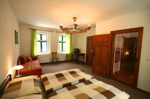 a living room with a bed and a couch at U Jindrů in Abertamy