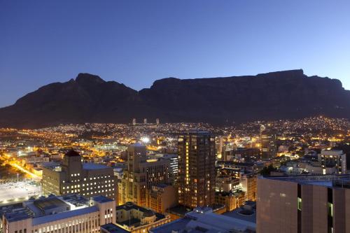 a view of a city with a mountain in the background at Southern Sun Cape Sun in Cape Town