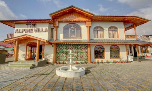 a building with a fountain in front of it at The Alpine Villa Mcleodganj in McLeod Ganj