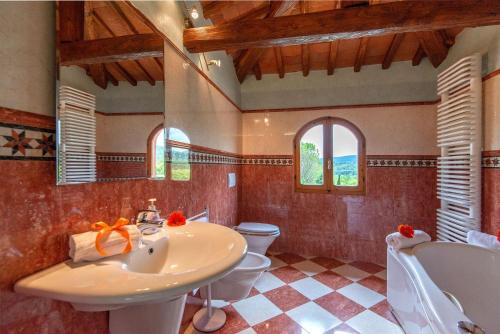 a bathroom with a sink and two toilets and a sink at Casale del Lago in San Casciano in Val di Pesa