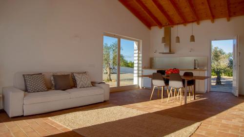 a living room with a couch and a table at Quinta da Pintassilga in Tavira
