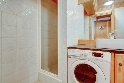 une machine à laver dans une salle de bain avec un lavabo dans l'établissement Lodge 3, à Morzine
