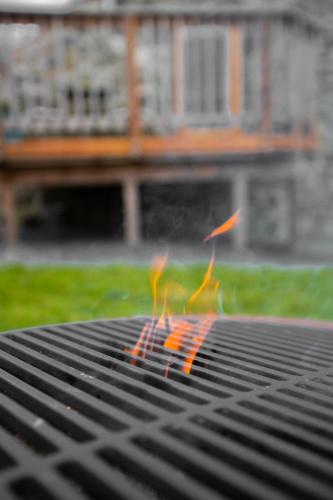 a grilling grate with orange flames on it at Snowdonia Hideaway in Tywyn