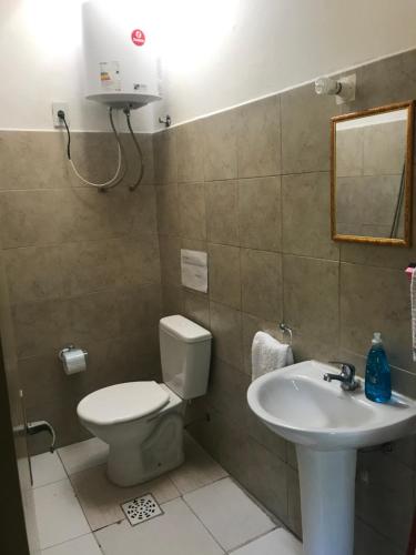 a bathroom with a toilet and a sink at Departamentos LT3 in Las Toscas